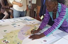 Susfish - woman circling on a map